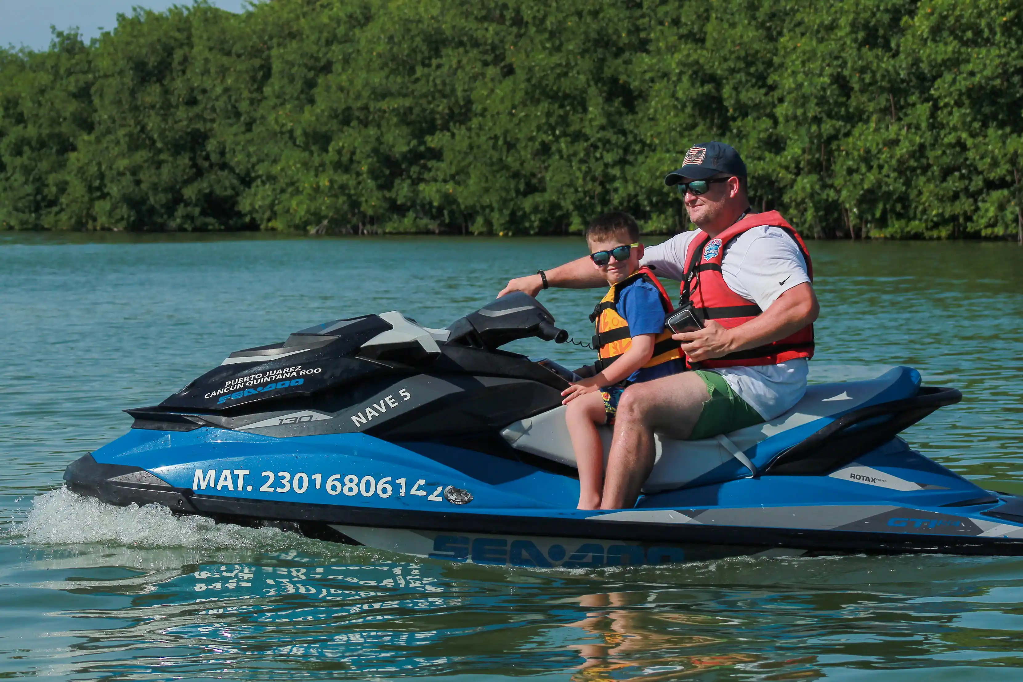 Father and son having fun at mangrove canal
